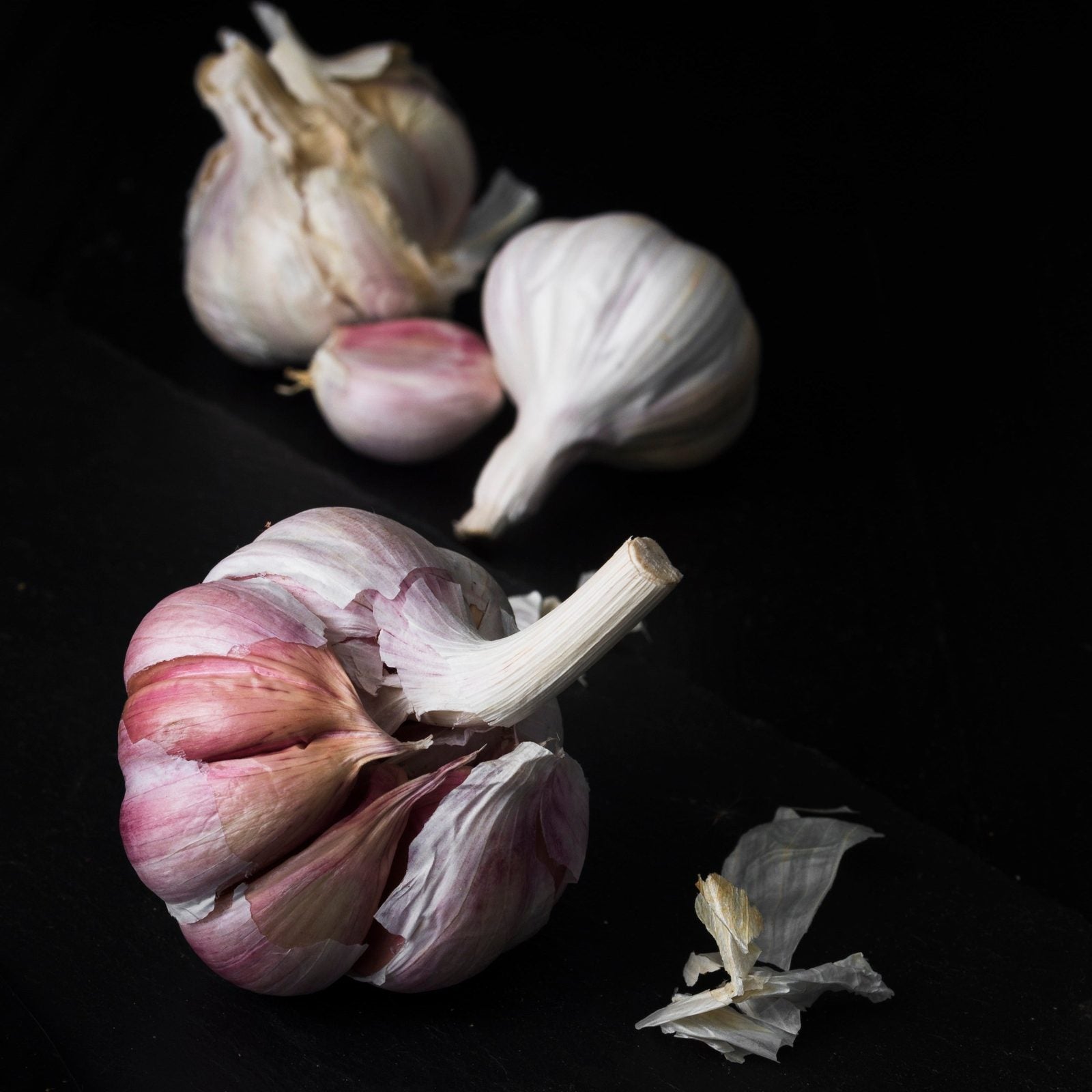 Close-up of fresh garlic cloves used in Black Magic salt