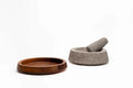 Mexican lava-stone pestle resting in molcajete bowl