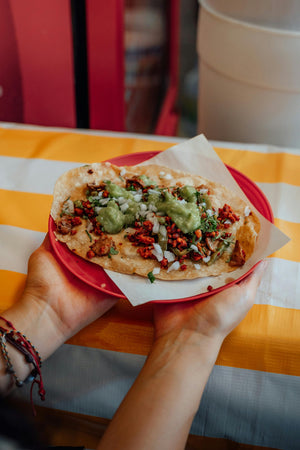 Mexican-style tacos on wooden plate with Papa Pastor seasoning